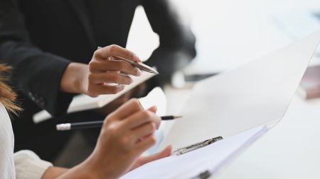 closeup of two people discussing divorce agreement document modifications