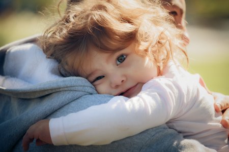 Child on father's shoulder in park - Paternity