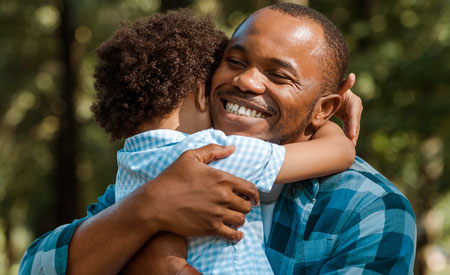 man hugging child